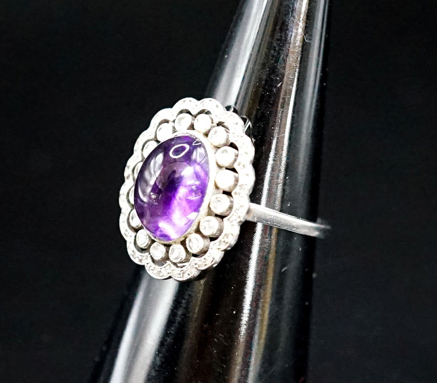 A 1920's white metal, cabochon amethyst and rose cut diamond ring, size M, gross weight 5.9 grams.